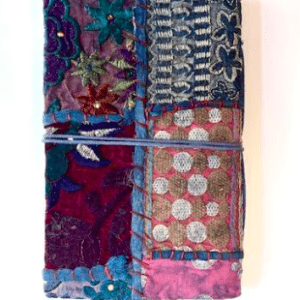 Hand-made from recycled sari fabric and recycled paper, these beautiful patchwork journals are sure to delight the artist or writer in your family. Each journal is uniquely made, so patches and patterns will vary on each product. Paper is unlined.